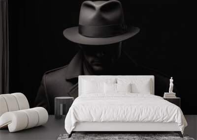 Mysterious Detective in Shadowy Silhouette wears a Fedora Hat and Trench Coat on black background Wall mural