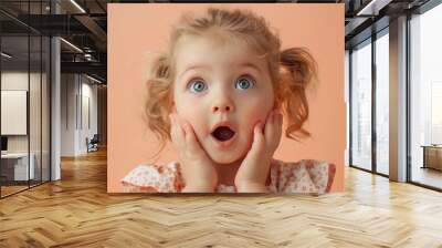 Studio portrait of a surprised toddler girl. Child facilities advertising concept. Wall mural