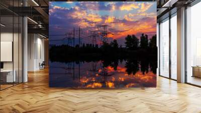 Electricity pylons and lines at dusk at sunset. Wall mural