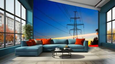 pylons and electricity powerlines at night with traffic lights in front. Wall mural