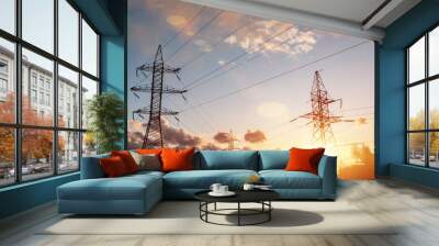 The silhouette of the evening electricity transmission pylon. Power transmission from a power plant to a city. Wall mural