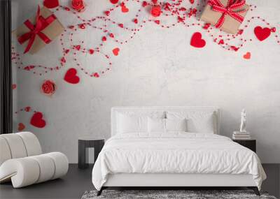 Two gifts with red ribbon and red beads with hearts on white stone background.Valentine's Day background. Valentine's Day concept. Flat lay. Wall mural