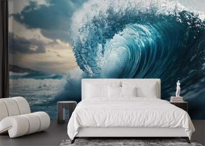 Majestic ocean wave crashing into the shore, reflecting sunlight beneath cloudy sky. Wall mural