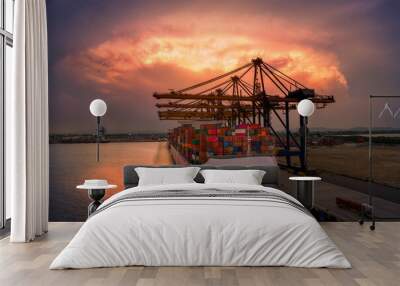 crane loading cargo container to container ship in the international terminal logistic sea port  concept freight shipping by ship at sunset Wall mural