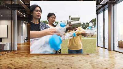 Woman Group Team Volunteer hand holding bottles garbage plastic Trash join empathy charity trust partner friendship. Volunteer team join hand at circle with bottles plastic Garbage waste at Park Wall mural