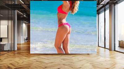 Woman in a red bikini at beach Wall mural