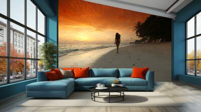 Woman walking on beach Wall mural