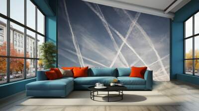 Airplane trails of condesed air in the sky Wall mural