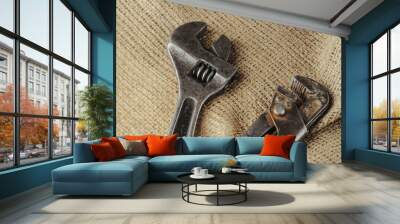 Two old adjustable wrench on a natural fabric background. Wall mural