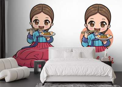 Cute girl sitting and eating tteokbokki or Korean spicy rice cake. Wall mural