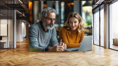 Diverse Team. Latin Businessman and European Businesswoman Collaborating on Laptop in Office Wall mural