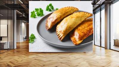 three baked whole delicious beef patties on grey plate on white concrete background jamaican chebureks stuffed with meat pastries from cuisine of an exotic country Wall mural