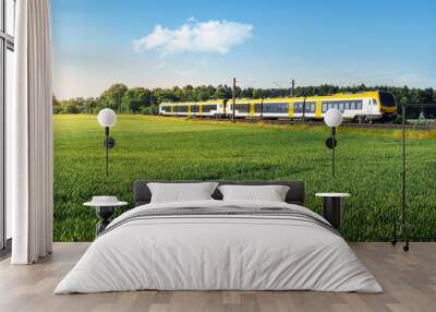 German passenger train in motion. Yellow electric train traveling Wall mural