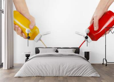 Hands squeezing ketchup and mustard out of plastic bottles, cut out Wall mural