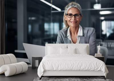 Professional female employee or a businesswoman using a laptop in a modern office. Copy space Wall mural