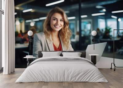 Professional female employee or a businesswoman using a laptop in a modern office. Copy space Wall mural