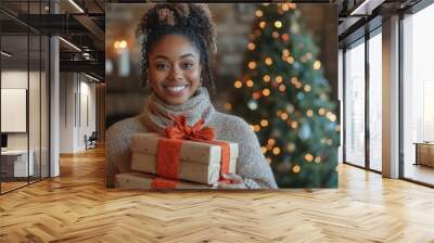 A Joyful Woman with Christmas Gifts in a Festive Living Room Wall mural