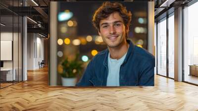 Happy Young Man Working on Computer at Night in Office Wall mural