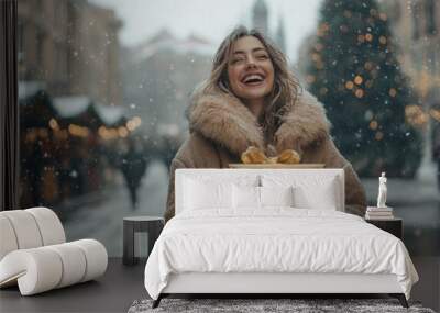 Joyful woman in fur coat with Christmas shopping bags Wall mural