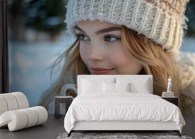 Young woman drinks coffee outdoors in snowy winter park Wall mural