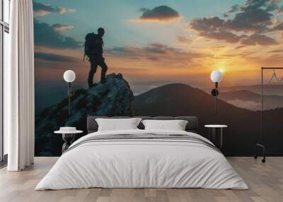 Adventurous male hiker scaling mountain summit at sunset   embracing extreme sports lifestyle Wall mural