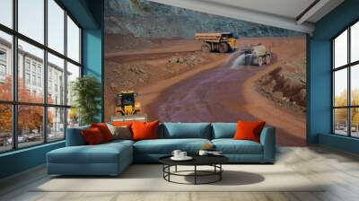 Heavy truck pours the road with water in the iron ore quarry. Dust removal, protection of the environment. Irrigation of the road from dust Wall mural