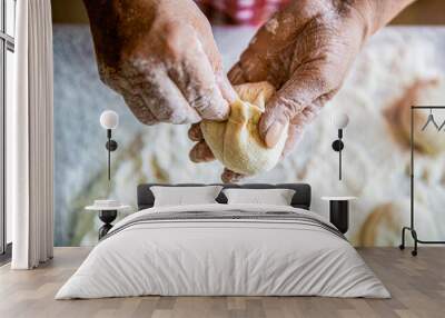 Homemade cakes dough in the women's hands. Process of making pies, hand. Hands pie dough. Cooks dough for baking, pieces of raw dough. Womans hands rolling doughs for pies. Baking at home Wall mural