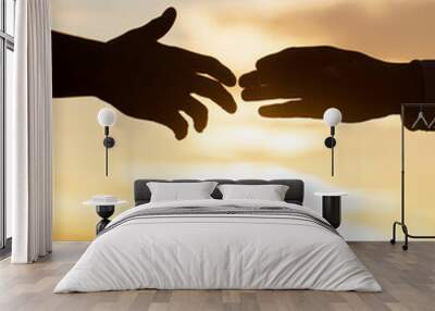 Rescue, helping gesture or hands. Two hands silhouette on sky background, connection or help concept. Outstretched hands, salvation, help silhouette, concept help. Giving a helping hand Wall mural