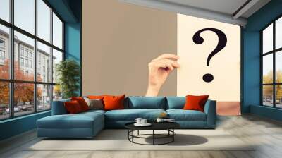 Woman holding interrogation symbol in front of her face. Female incognita. Girl question, anonymous, incognita. Girl holding paper question mark. Anonymous, woman question, incognita. Anonymous woman Wall mural