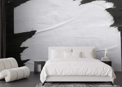 A sheet of white paper glued on a black wall. Wall mural