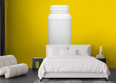 White plastic jar of pesticides on a yellow background. Wall mural