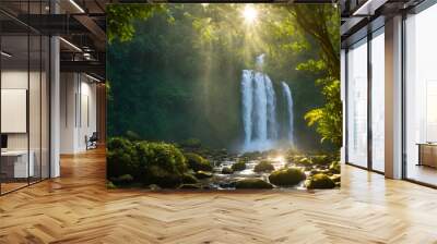 Shallow river near a picturesque waterfall and sunbeams through thick thickets of trees. Wall mural