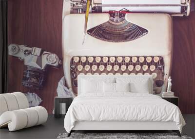 an old typewriter on old wooden table with coffee and old camera Wall mural