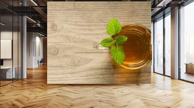 cup of tea with mint on wooden table Wall mural