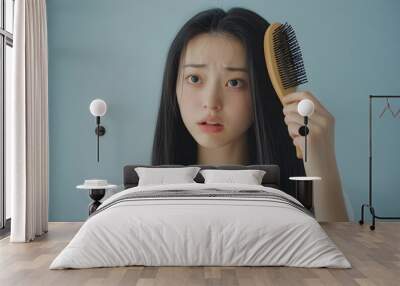 Asian Woman Concerned About Thinning Hair in Natural Light. Wall mural