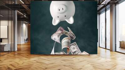 Dollar banknotes falling out of the upside down piggy bank Wall mural