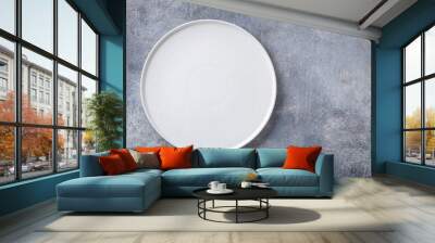 Empty white plate on gray concrete background. Top view, with copy space Wall mural