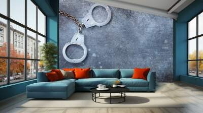 Handcuffs on grunge a grunge deep blue background Wall mural