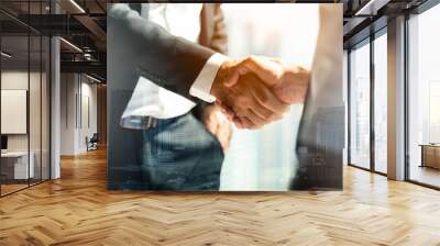 Businessman handshake for teamwork of business merger and acquisition,successful negotiate,hand shake,two businessman shake hand with partner to celebration partnership and business deal concept Wall mural