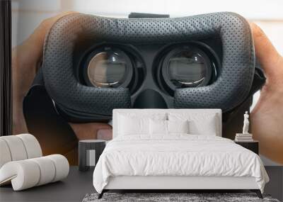 looking inside a vr or ar headset on white.Hand holding VR glasses. Wall mural