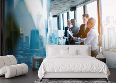 Meeting and discussion concept.business people communicating in office.Mature businessman discuss information with a colleague in a modern business lounge high up in an office tower. Wall mural