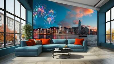 A city skyline with fireworks and a sunset, reflected in the water. Wall mural