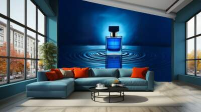 A glass bottle of perfume with a blue liquid stands in a blue pool of water.  The bottle is creating ripples in the water. Wall mural