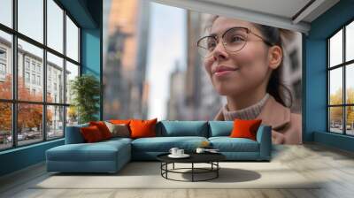 A happy young businesswoman with glasses standing in the financial district of a mordern metropolis. generative AI Wall mural