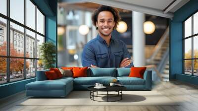 A smiling confident young business man standing with arms crossed in a modern office. a happy handsome curly haired male entrepreneur with his hands folded across his chest. generative AI Wall mural