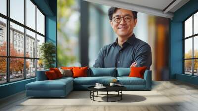 Happy confident professional Korean business man of mature standing in office. 40 years old business owner, company manager, smiling senior ceo executive, corporate leader at work. Wall mural