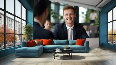 Smiling young male bank manager listening at team work office meeting or job interview sitting at table. generative AI Wall mural