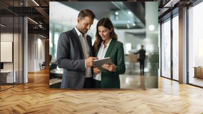 two male and female businessmen looking at digital tablet in company lobby, in the style of joyful, light gray and dark emerald, urban. generative AI Wall mural