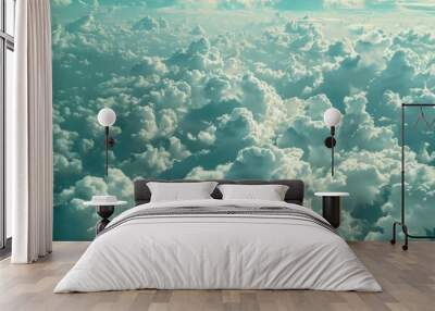 Aerial view of fluffy white clouds covering blue sky Wall mural