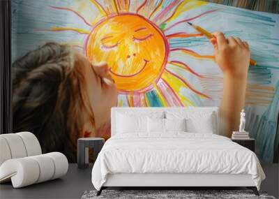 Little girl drawing a smiling sun on a white paper with colorful pencils, enjoying her art Wall mural